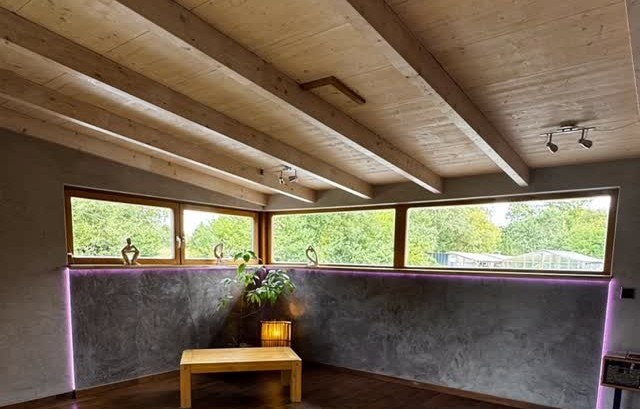 Finished charcoal plaster wall that hides the heating system
